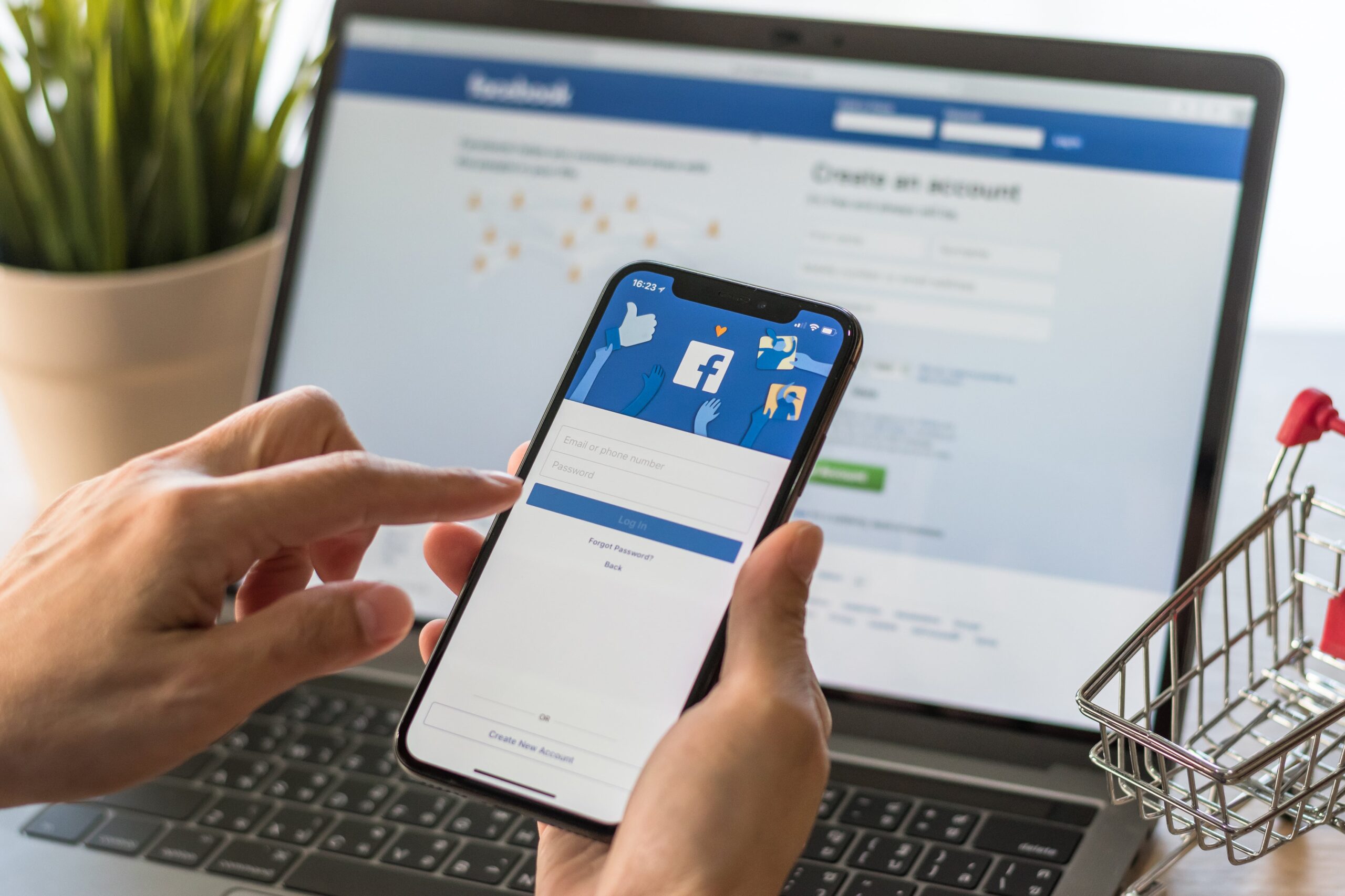 person holding a phone and browsing facebook