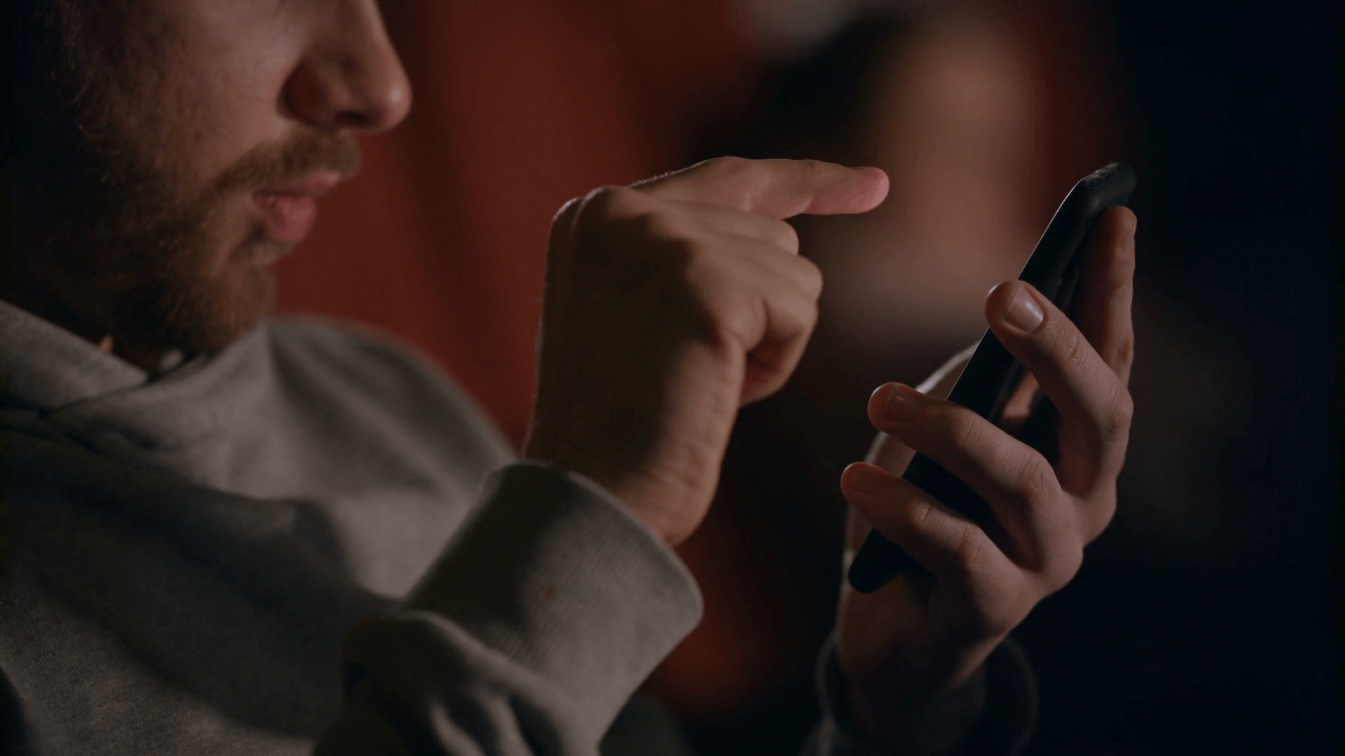 person scrolling on his phone