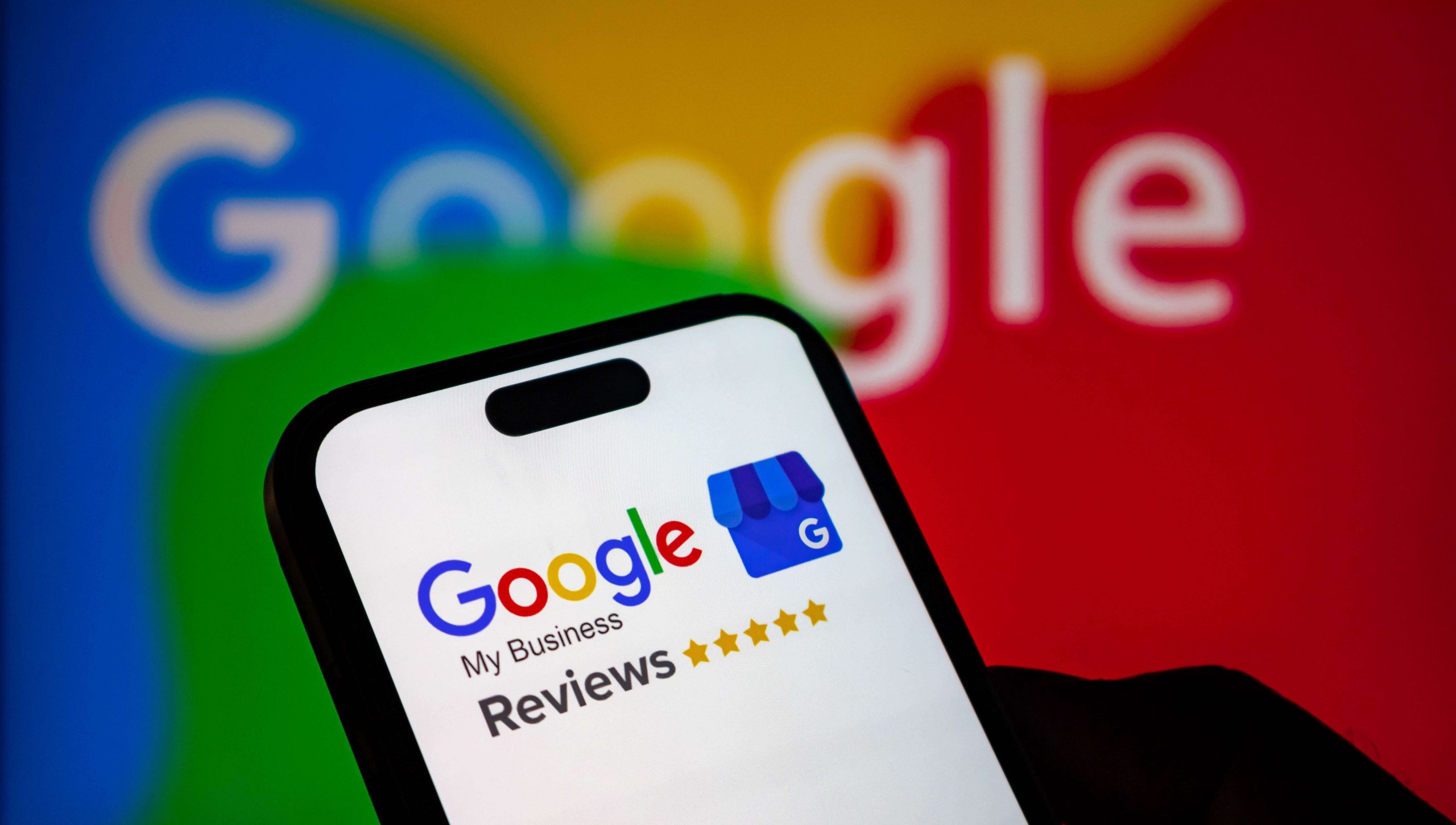 Closeup of a smartphone screen displaying the google my business reviews logo